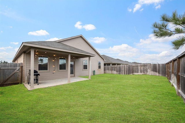 back of property featuring a lawn and a patio