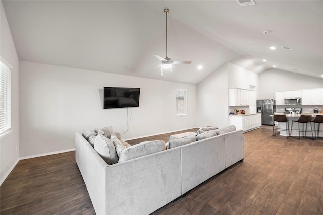 living room with dark hardwood / wood-style floors, ceiling fan, and vaulted ceiling