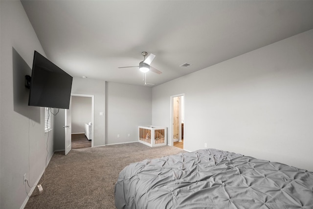 bedroom with ceiling fan, carpet floors, and ensuite bathroom