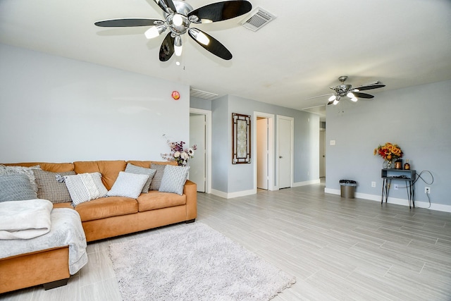 living room featuring ceiling fan and wood-type flooring