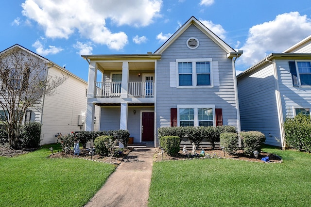 view of front of house featuring a balcony and a front lawn