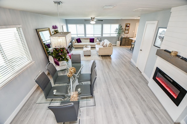 living room with ceiling fan and light hardwood / wood-style floors