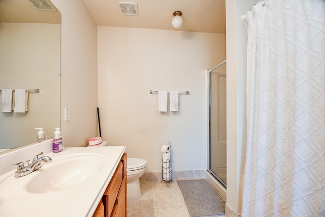 bathroom featuring tile patterned flooring, vanity, toilet, and curtained shower