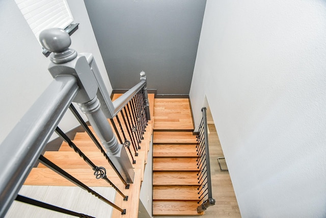 stairs with hardwood / wood-style floors