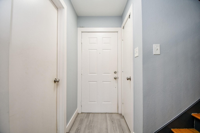 doorway to outside with light wood-type flooring