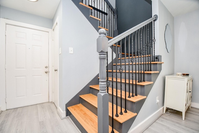 stairs featuring wood-type flooring