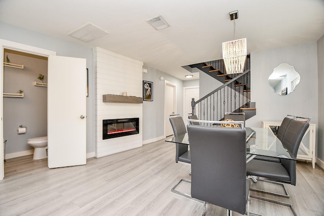 dining area featuring a notable chandelier and light hardwood / wood-style flooring