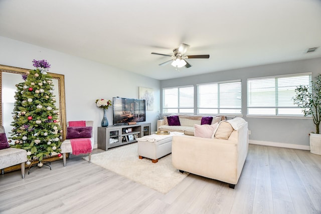 living room with light hardwood / wood-style flooring and ceiling fan