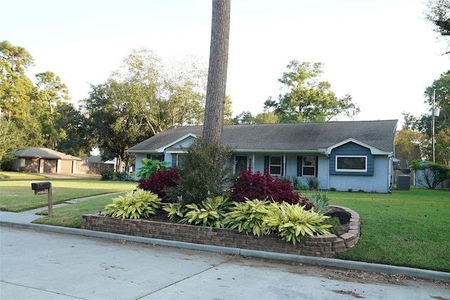 single story home with an outbuilding and a front lawn