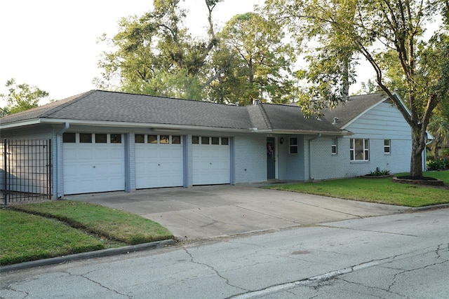 single story home featuring a garage and a front lawn