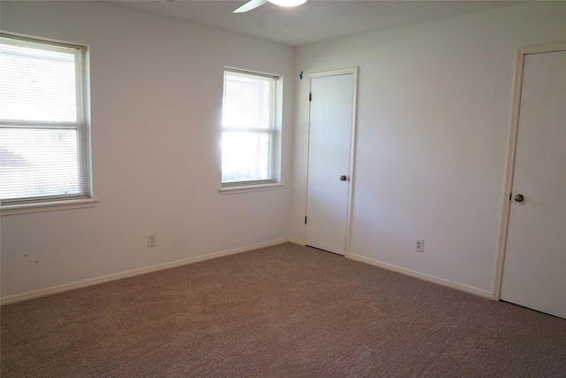 spare room with carpet floors and ceiling fan