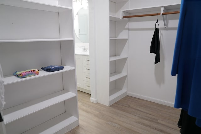 spacious closet with light hardwood / wood-style floors