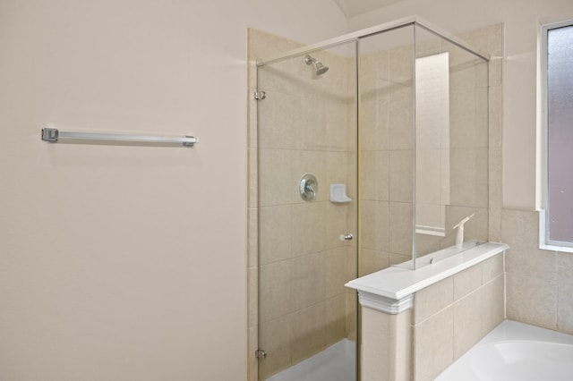 bathroom featuring separate shower and tub