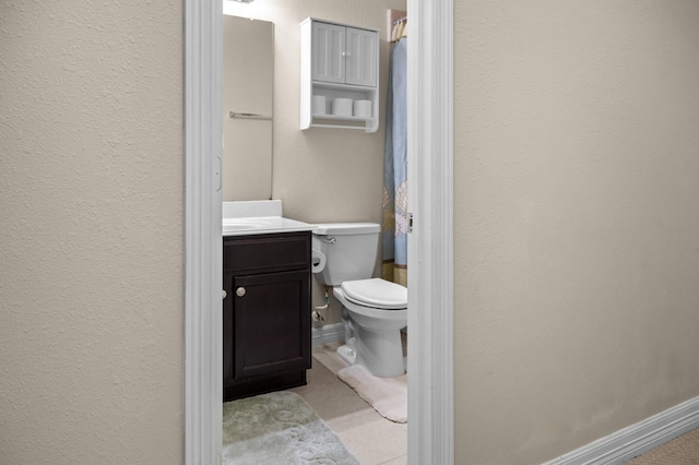 bathroom with tile patterned floors, vanity, and toilet