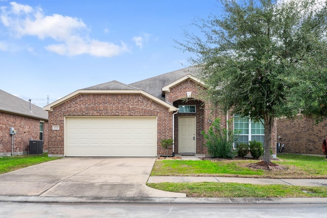 view of front of property featuring a garage and central AC