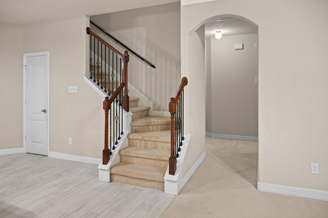 stairway with hardwood / wood-style floors