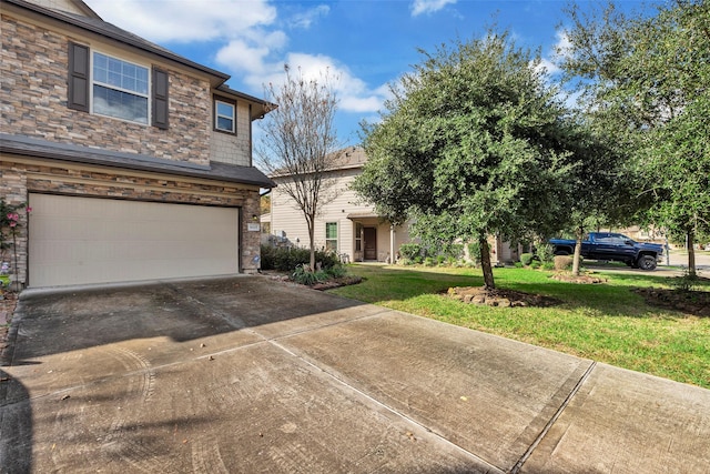 view of front of home featuring a front yard and a garage