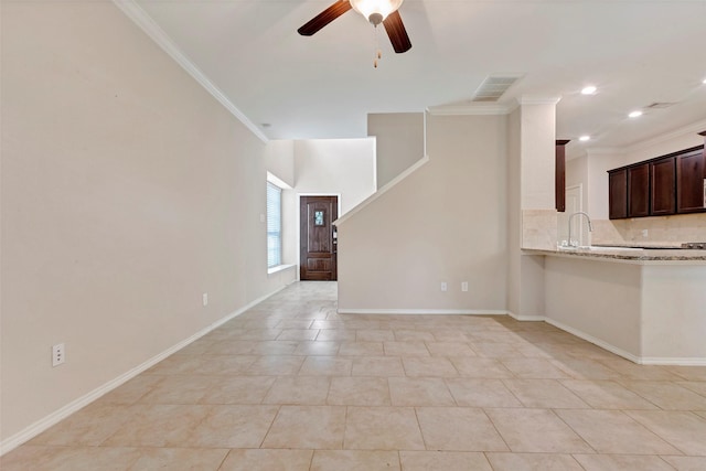 unfurnished living room with crown molding, sink, light tile patterned flooring, and ceiling fan