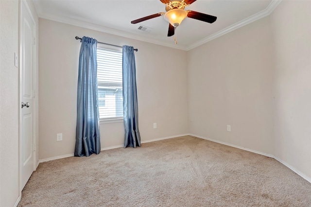 carpeted empty room with a wealth of natural light, ornamental molding, and ceiling fan