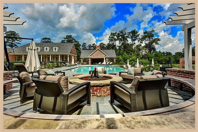 view of pool with an outbuilding and a patio