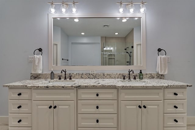 bathroom featuring vanity and an enclosed shower