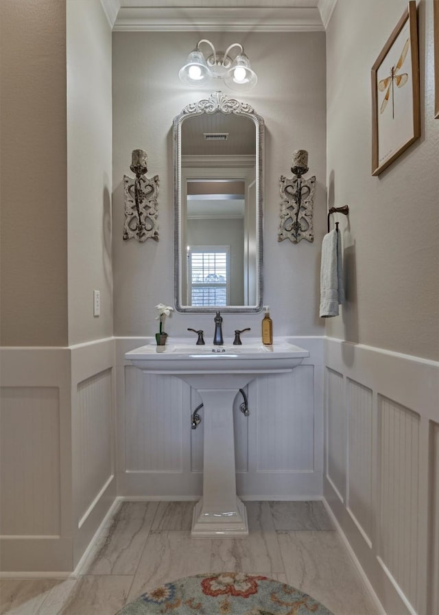 bathroom featuring sink and crown molding