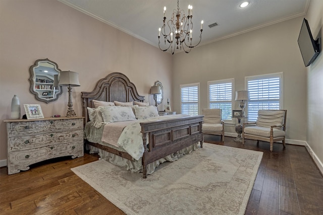 bedroom featuring dark hardwood / wood-style floors, crown molding, and an inviting chandelier