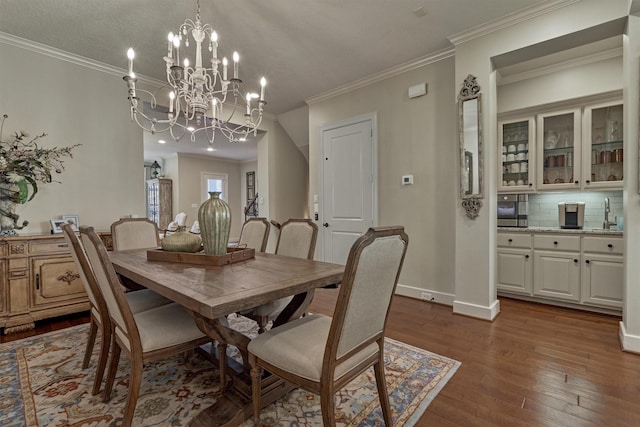 dining area with dark hardwood / wood-style floors, ornamental molding, a textured ceiling, and a chandelier