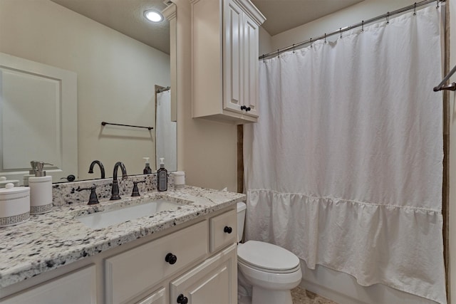 full bathroom with vanity, shower / bath combination with curtain, and toilet