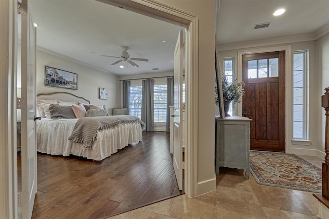 bedroom with ceiling fan, ornamental molding, and light hardwood / wood-style flooring