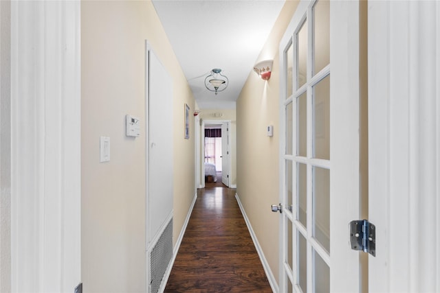 corridor with dark wood-type flooring