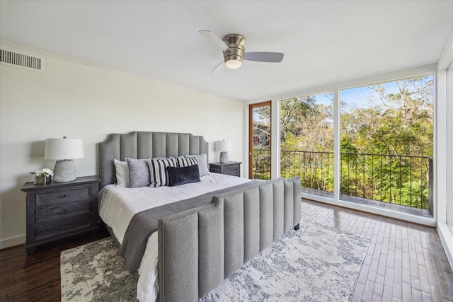 bedroom with ceiling fan, dark hardwood / wood-style flooring, and expansive windows