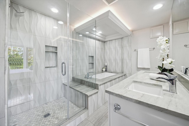 bathroom with vanity, independent shower and bath, and tile walls