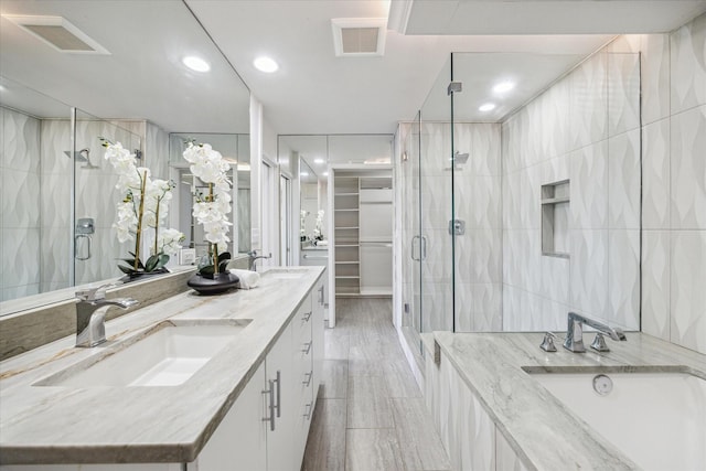 bathroom featuring vanity, an enclosed shower, and tile walls