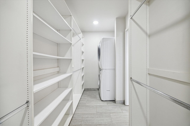 spacious closet featuring stacked washer / drying machine