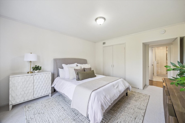 bedroom with light carpet, a closet, and ornamental molding