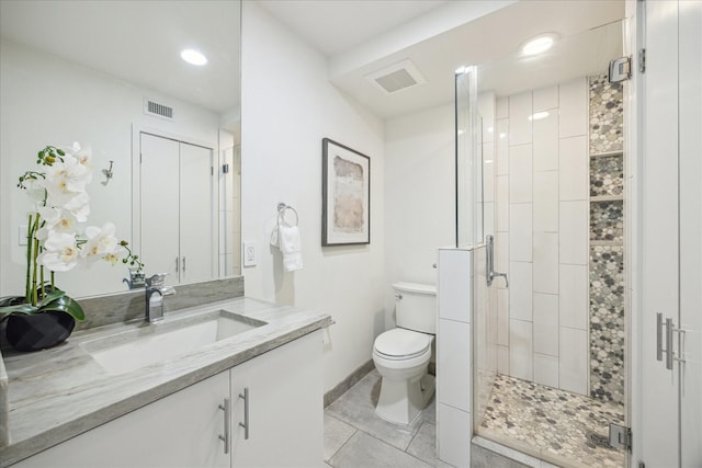 bathroom featuring tile patterned flooring, vanity, an enclosed shower, and toilet