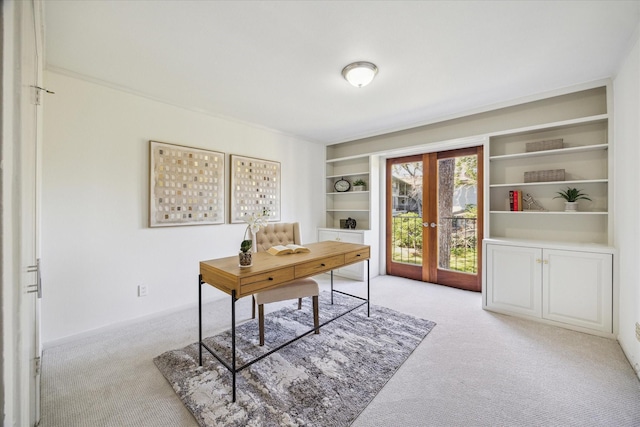 home office featuring built in features, light carpet, and french doors