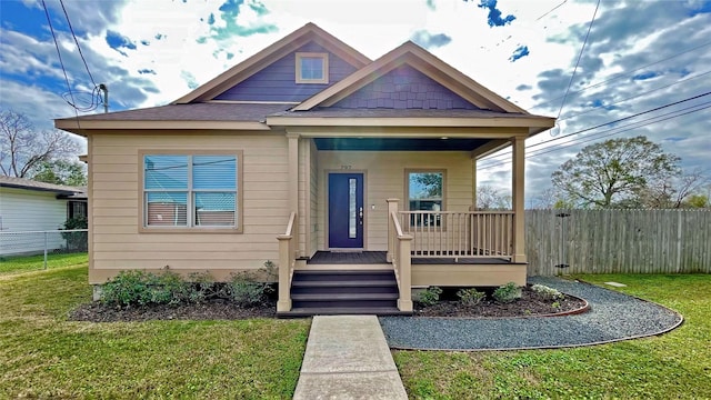 bungalow-style home featuring a porch and a front lawn