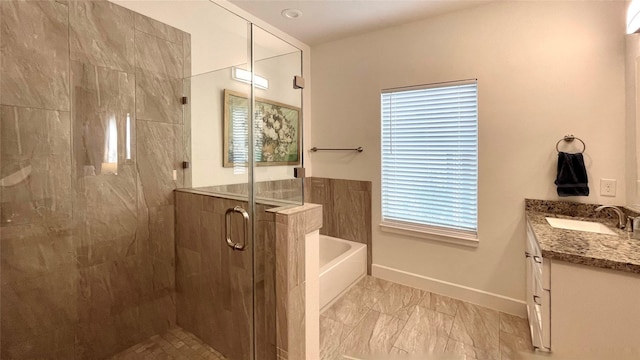 bathroom featuring vanity and separate shower and tub