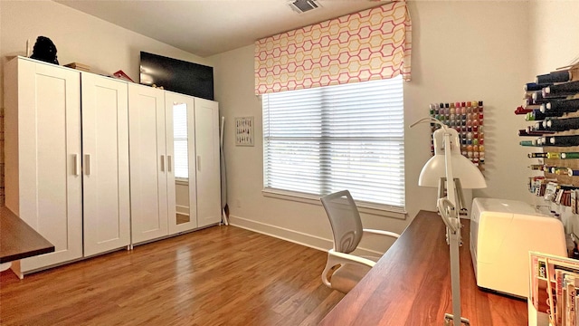 home office with hardwood / wood-style floors and lofted ceiling