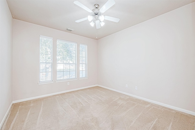 spare room with light carpet and ceiling fan