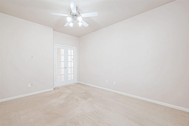 unfurnished room with ceiling fan, light carpet, and french doors