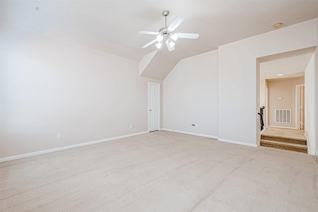 additional living space with ceiling fan, lofted ceiling, and light carpet