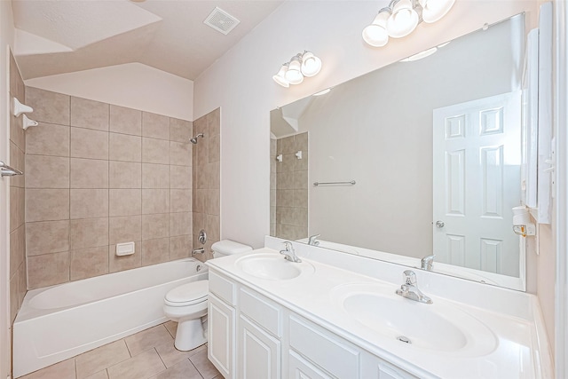 full bathroom with tile patterned flooring, vanity, toilet, and tiled shower / bath