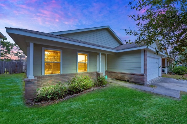 view of front of home with a yard and a garage