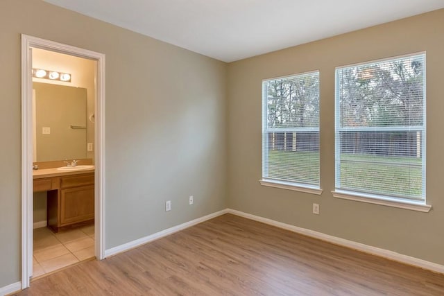 empty room featuring sink and light wood-type flooring