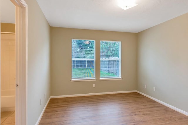 empty room with light hardwood / wood-style flooring