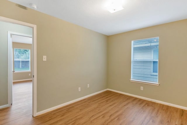 unfurnished room featuring light hardwood / wood-style floors