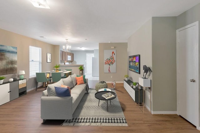 living room featuring hardwood / wood-style flooring and a notable chandelier